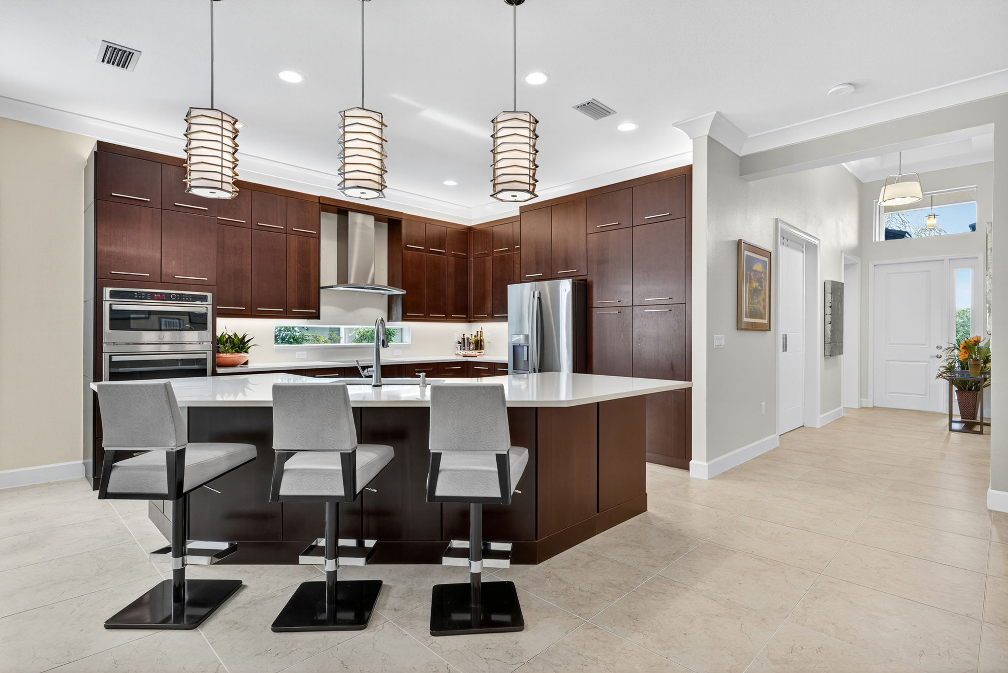 There's seating for 7 at this island! The double wall oven doubles as a microwave! The pantry boasts slide out shelves! The backsplash window and the chimney hood are appreciated upgrades!