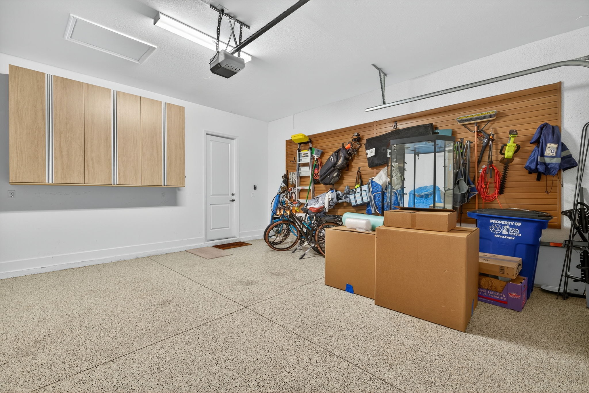 Epoxy fllor, exterior side 'man' door, hanging storage cabinets and wall mounted storage system will convey!