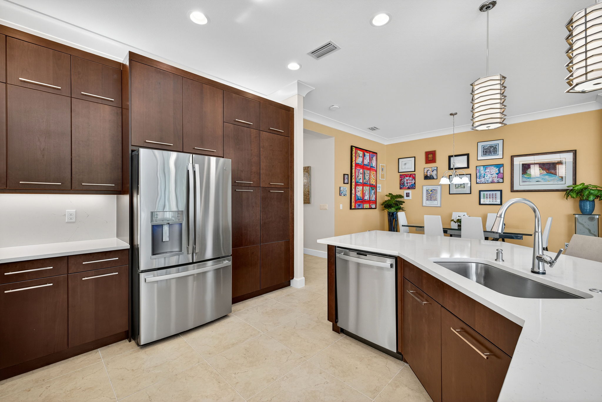 French door fridge, custom pendant lighting, selected pull out drawers in lower cabinets all combine with a functional workflow in this custom kitchen!