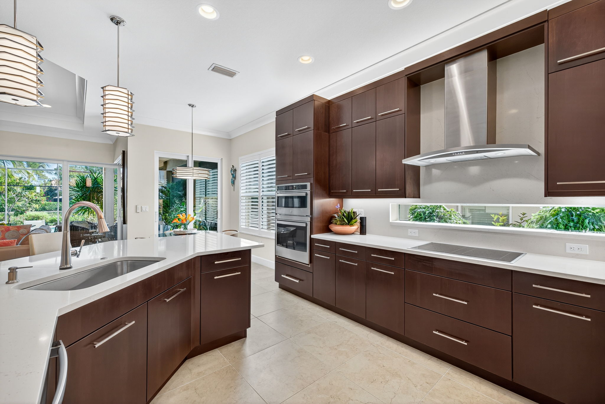 One large sink, under cabinet lighting, matching horizontal hardware, floor to ceiling cabinets all combine to make this kitchen a show stopper!