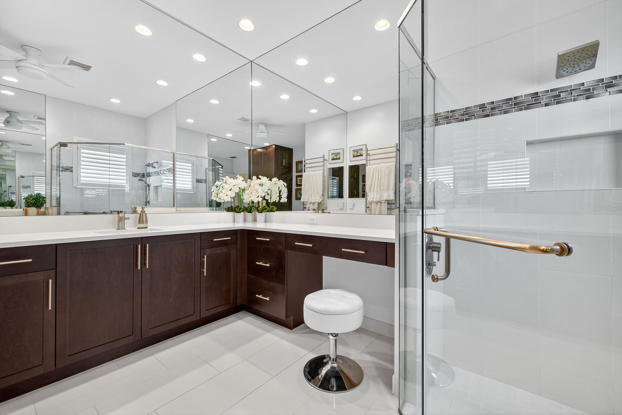 Upgraded ceiling height mirrors, floor to ceiling tile in shower, two sink areas, vanity area AND a towel warmer rack. Say hello to your primary bath!