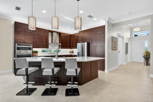 There's seating for 7 at this island! The double wall oven doubles as a microwave! The pantry boasts slide out shelves! The backsplash window and the chimney hood are appreciated upgrades!