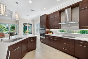 One large sink, under cabinet lighting, matching horizontal hardware, floor to ceiling cabinets all combine to make this kitchen a show stopper!