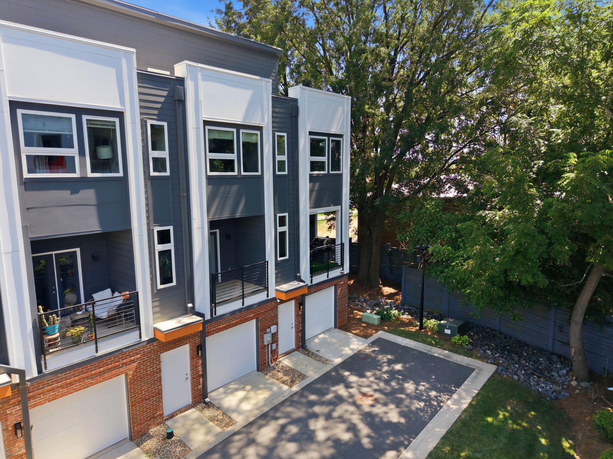 End-Unit Rear Exterior Beneath a Mature Tree Canopy