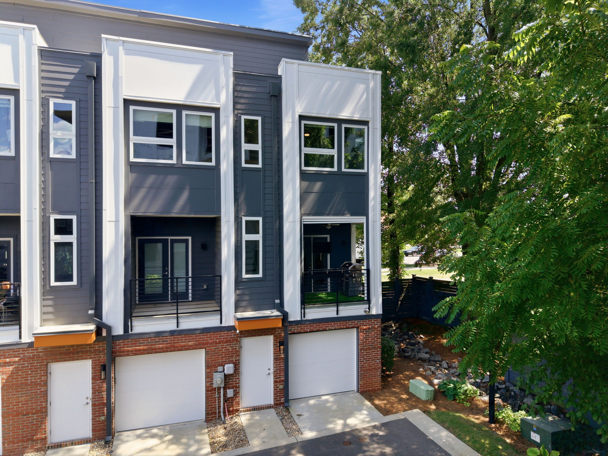 End-Unit Rear Exterior Beneath a Mature Tree Canopy