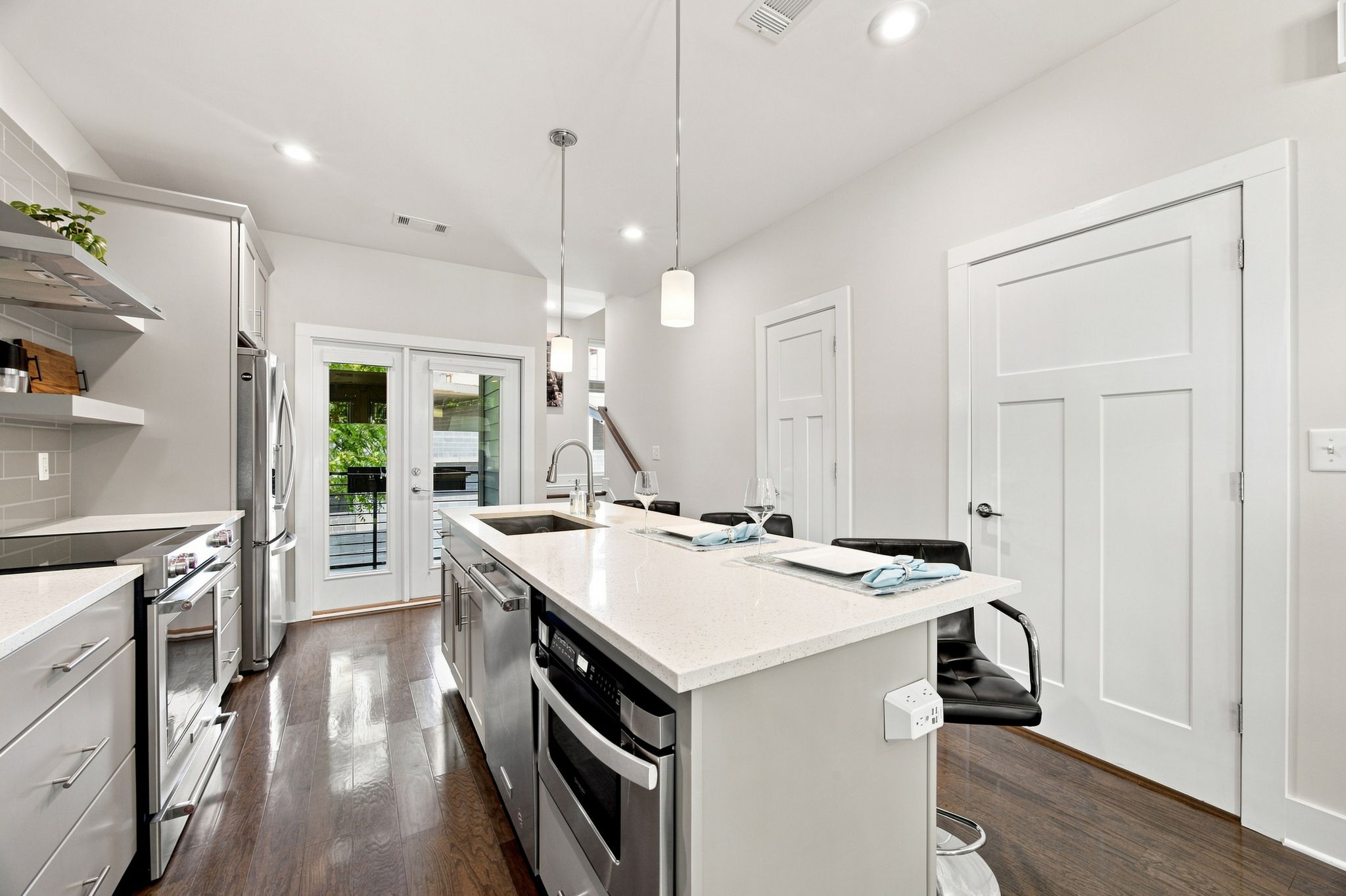 Spacious Kitchen with Stainless Steel Appliances and Island Seating
