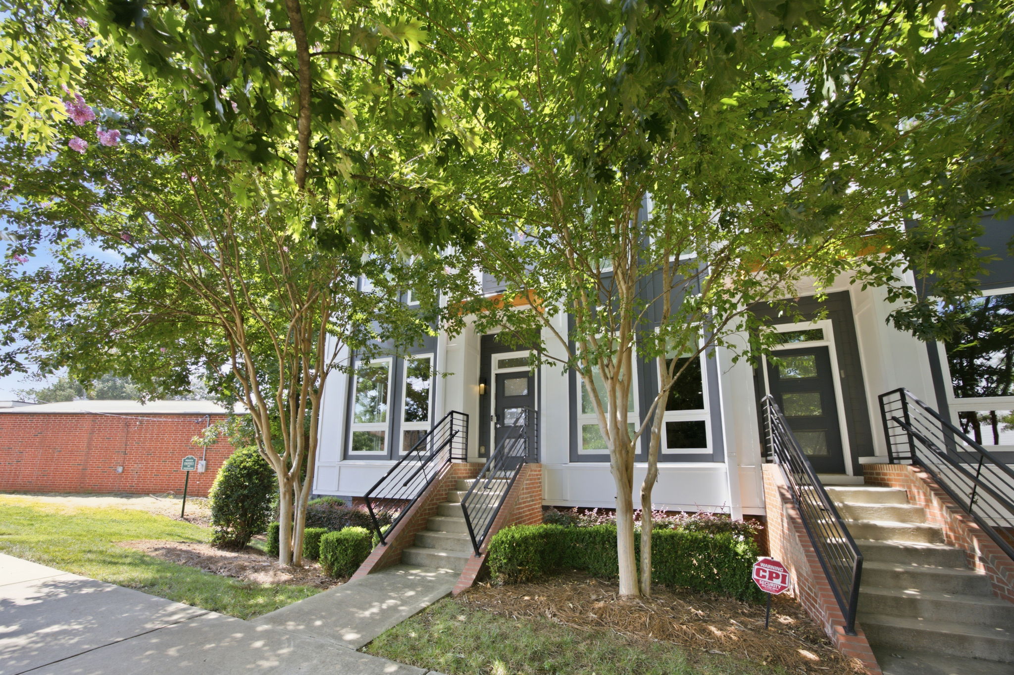 Landscaped Front Exterior Framed by Mature Trees