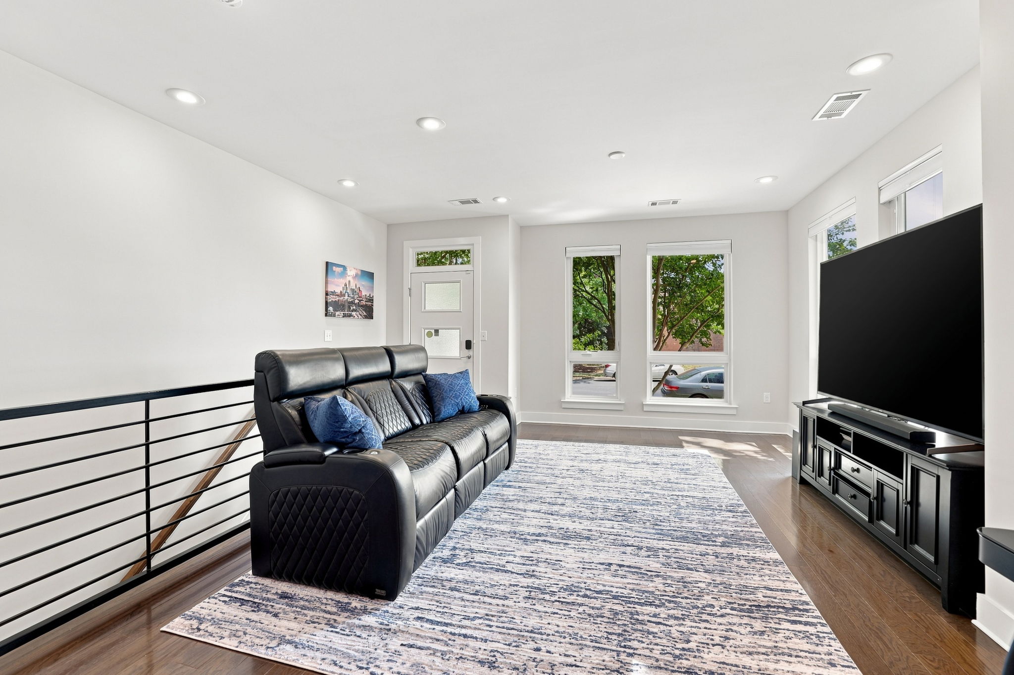 Living Room with Oversized Windows and Open Stair Railing