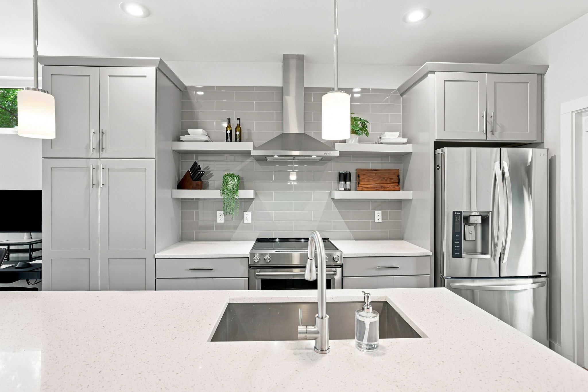 Kitchen with Range Hood, Tile Backsplash, and Floating Shelves