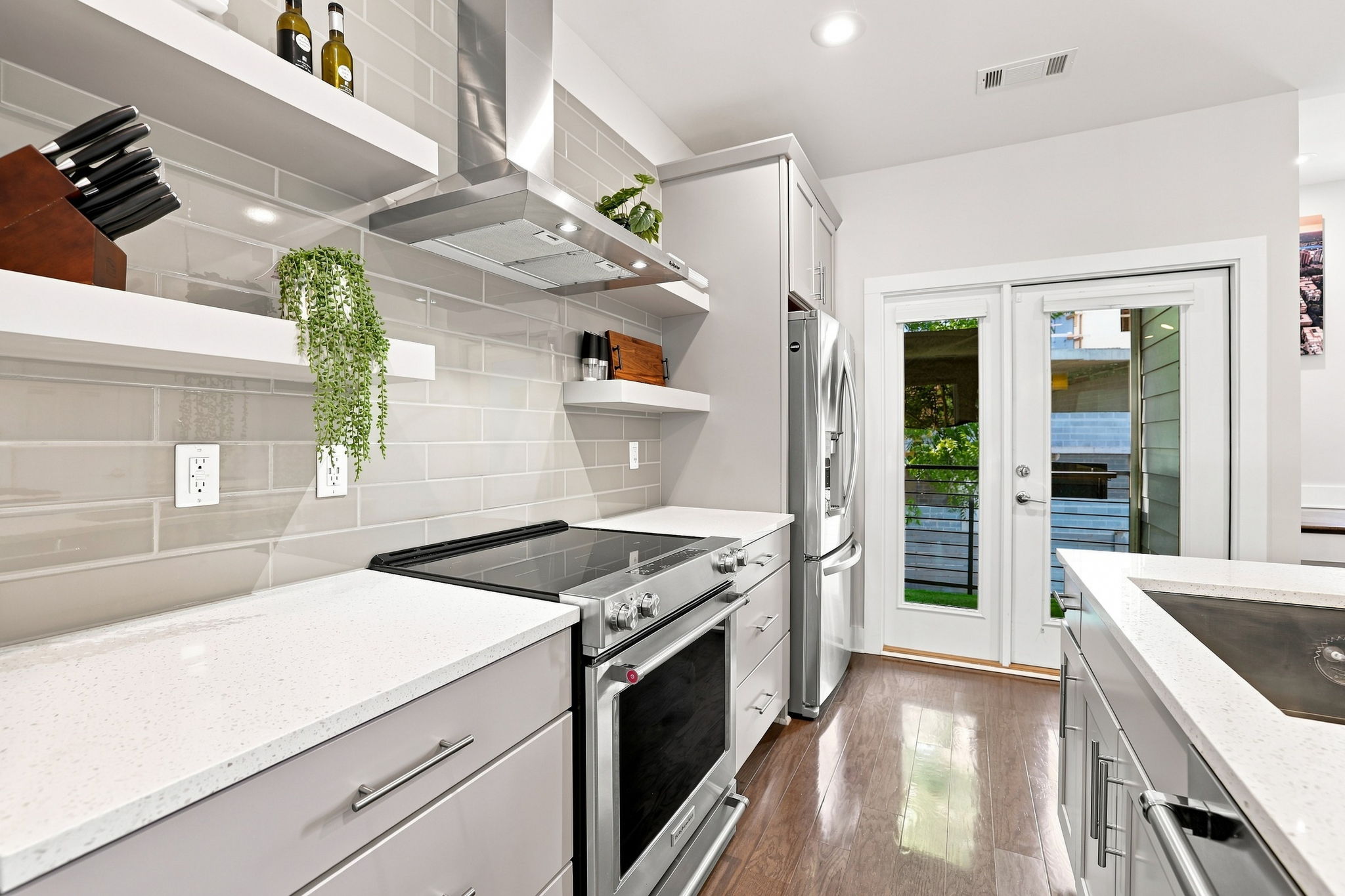 Stainless Steel Range, Floating Shelves, and Direct Patio Access