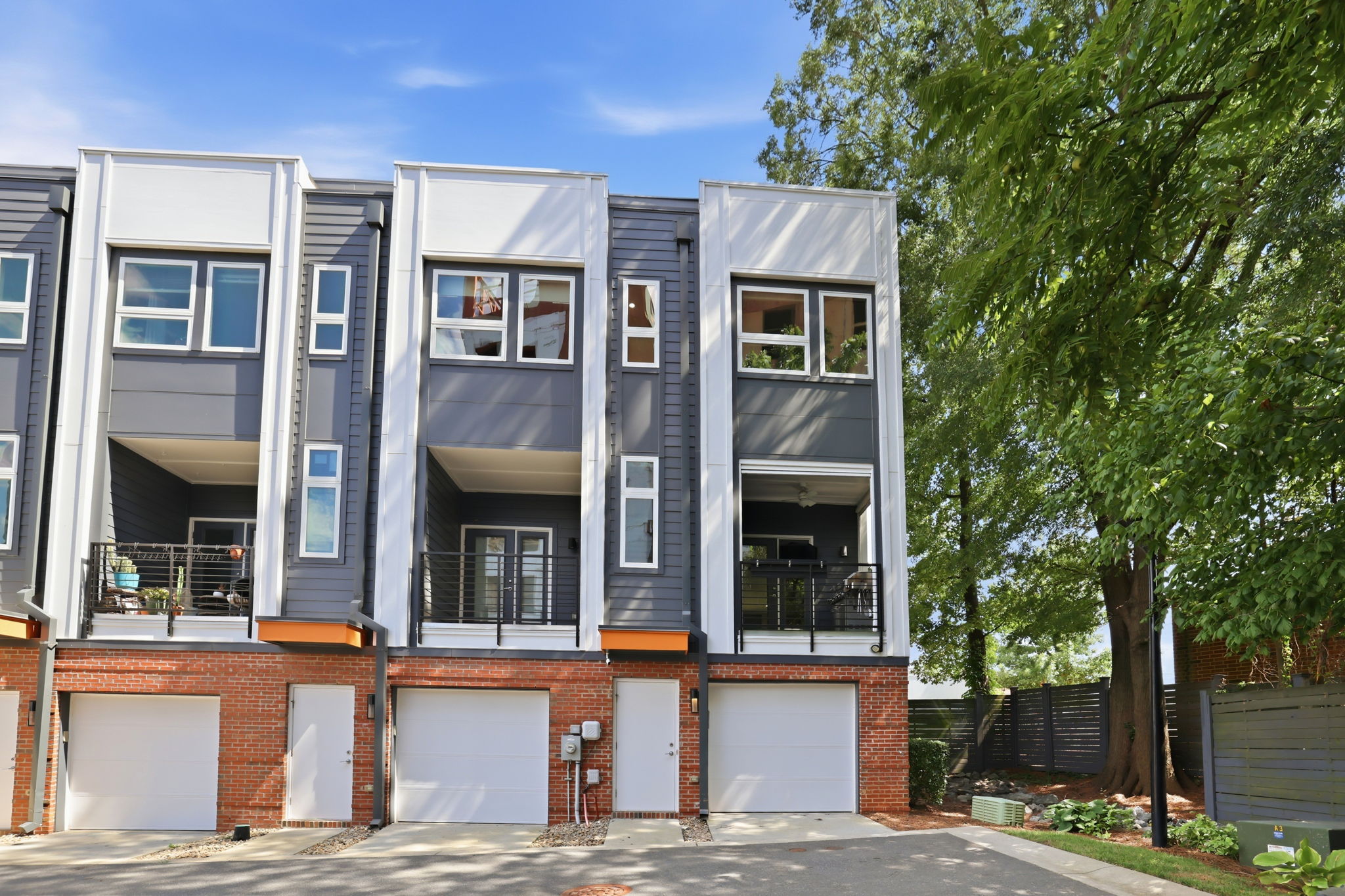 End-Unit Rear Exterior Beneath a Mature Tree Canopy