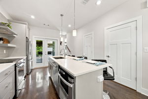 Spacious Kitchen with Stainless Steel Appliances and Island Seating