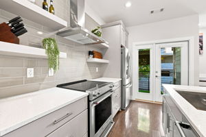 Stainless Steel Range, Floating Shelves, and Direct Patio Access