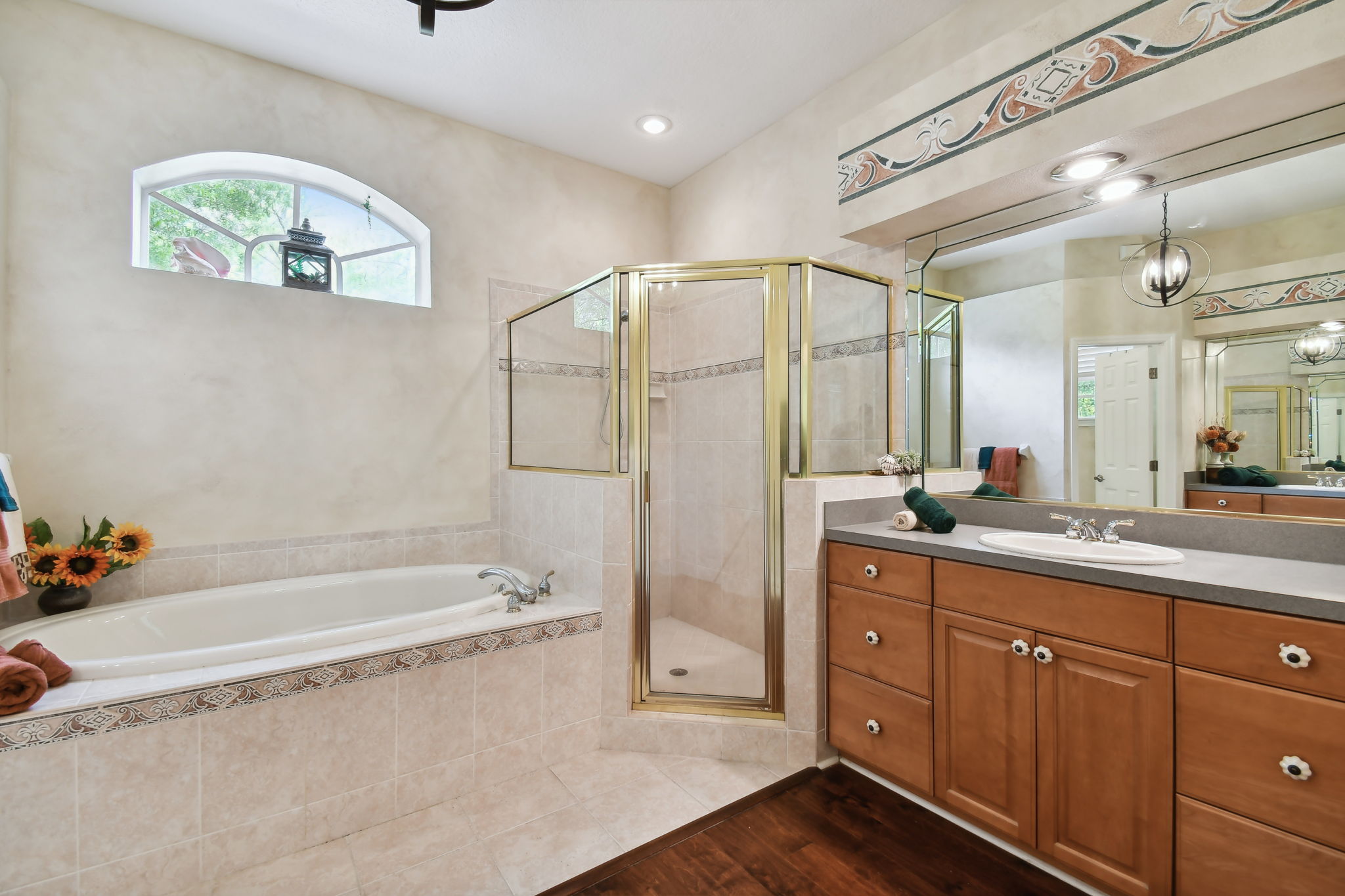 jetted tub and separate shower in owner's bedroom
