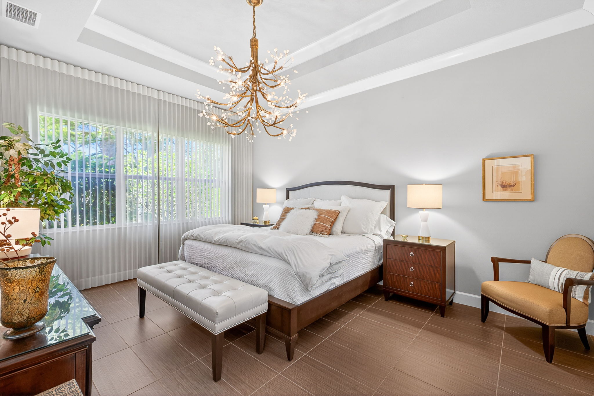 Elegance abounds here with the gold chandelier, soft, designer custom blinds cover the entire wall of windows. Room holds a king bed, 2 nightstands, dresser and a chair!