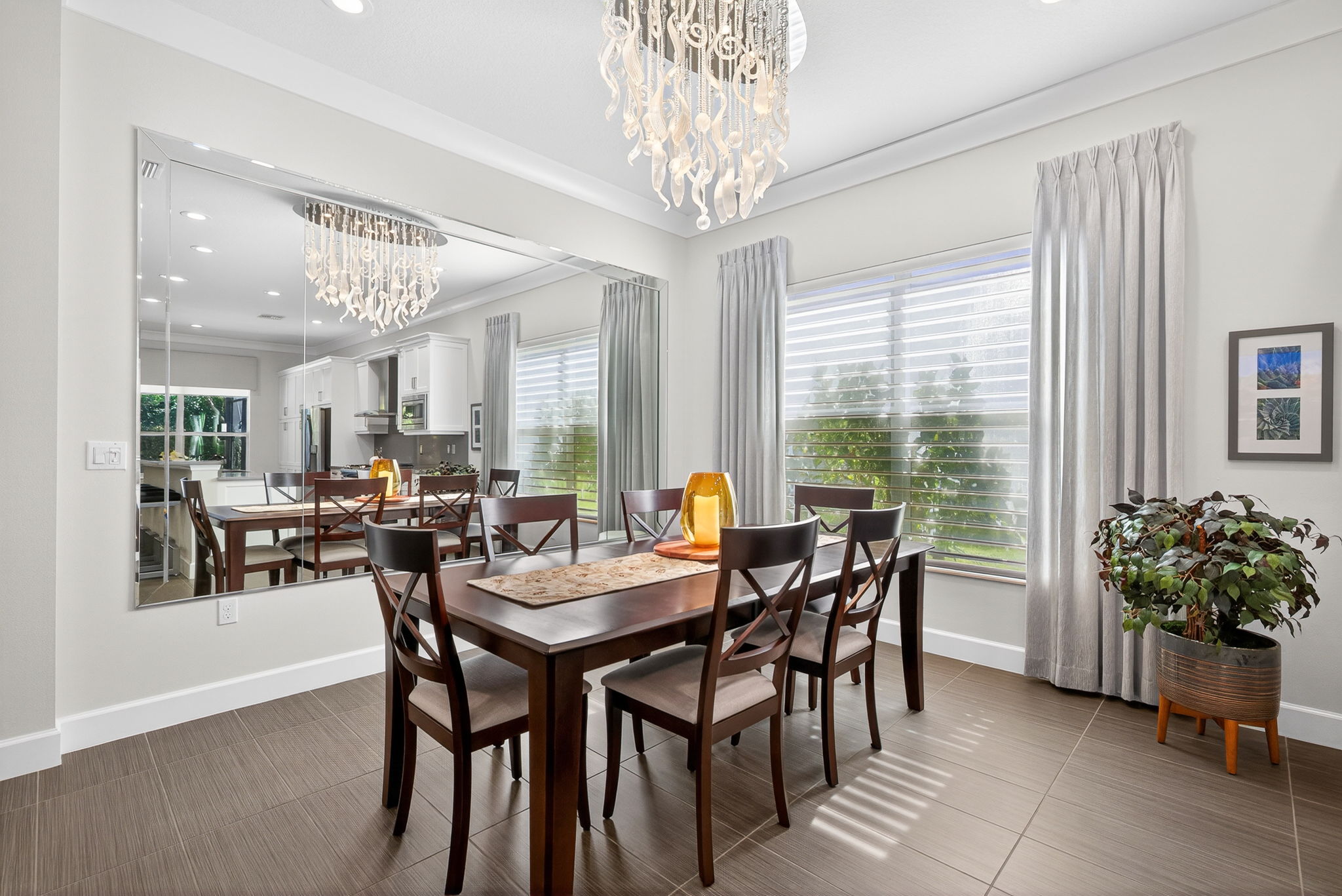 This dining space will comfortably hold a table that seats 8-10, plus 4 at bar plus 4 in breakfast area...Yay! Custom mirror reflects sunlight to make this room cheery! Note the reflection of the amazing chandelier in the mirror!