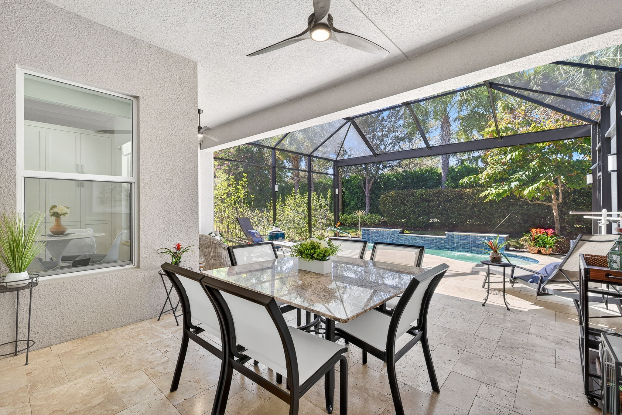 IMAGINE the serenity of listening to the dual waterfall features in your heated, saltwater pool with spa features! Night lighting present, as are travertine tiles, ceiling fans, 'panoramic view" lanai screens, and privacy of rear lush landscaping.