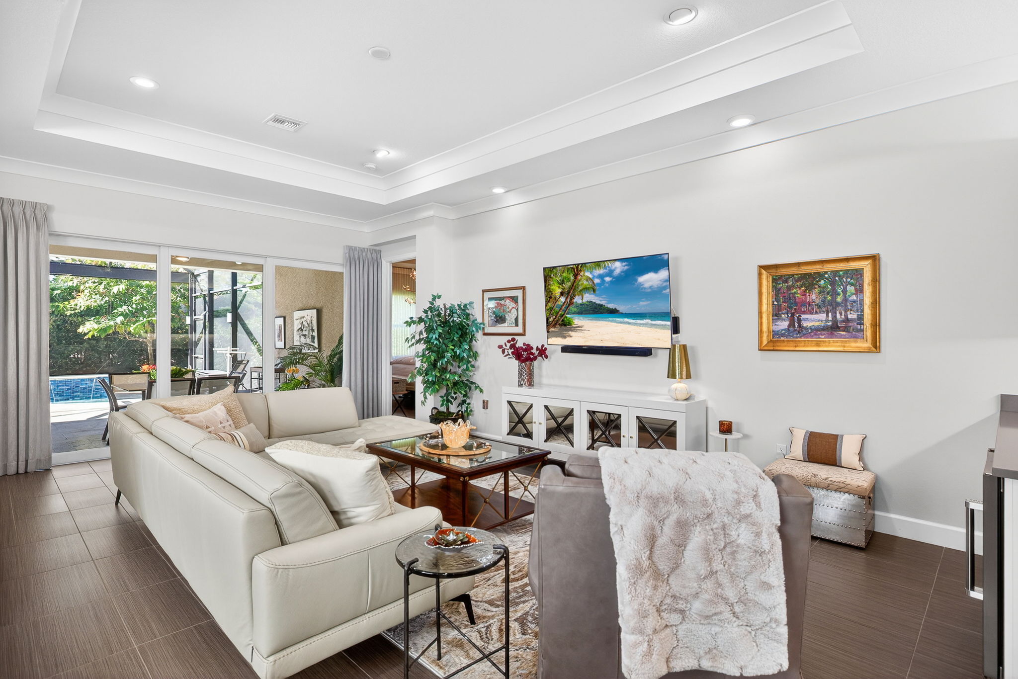 Custom window treatments including motorized window shades, cornices and plantation shutters. Note the crown molding and tray ceiling!