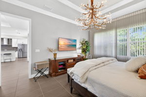 Other view of primary bedroom with crown molding, TWO walk-in closets, and large ensuite bathroom.