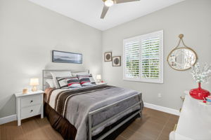 Third bedroom features 2 windows, plantation shutters and beautiful plank tile flooring.