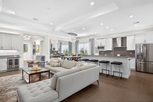 See the built-in wine bar? Complete with wine fridge, premium cabinetry, above and below cabinet lighting, and quartz counters! Great for entertaining!..