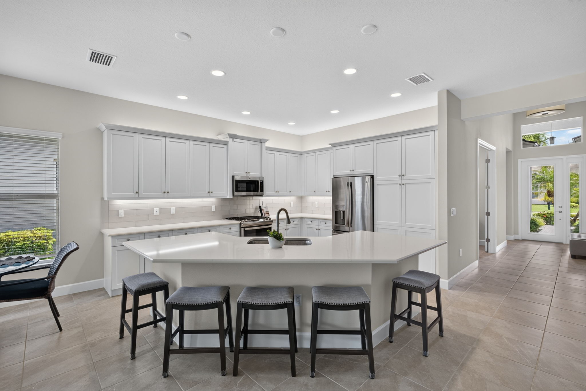 Quartz countertops, seating for 5 at bar, large pantry, and above and below cabinetry lighting are all yours to enjoy!