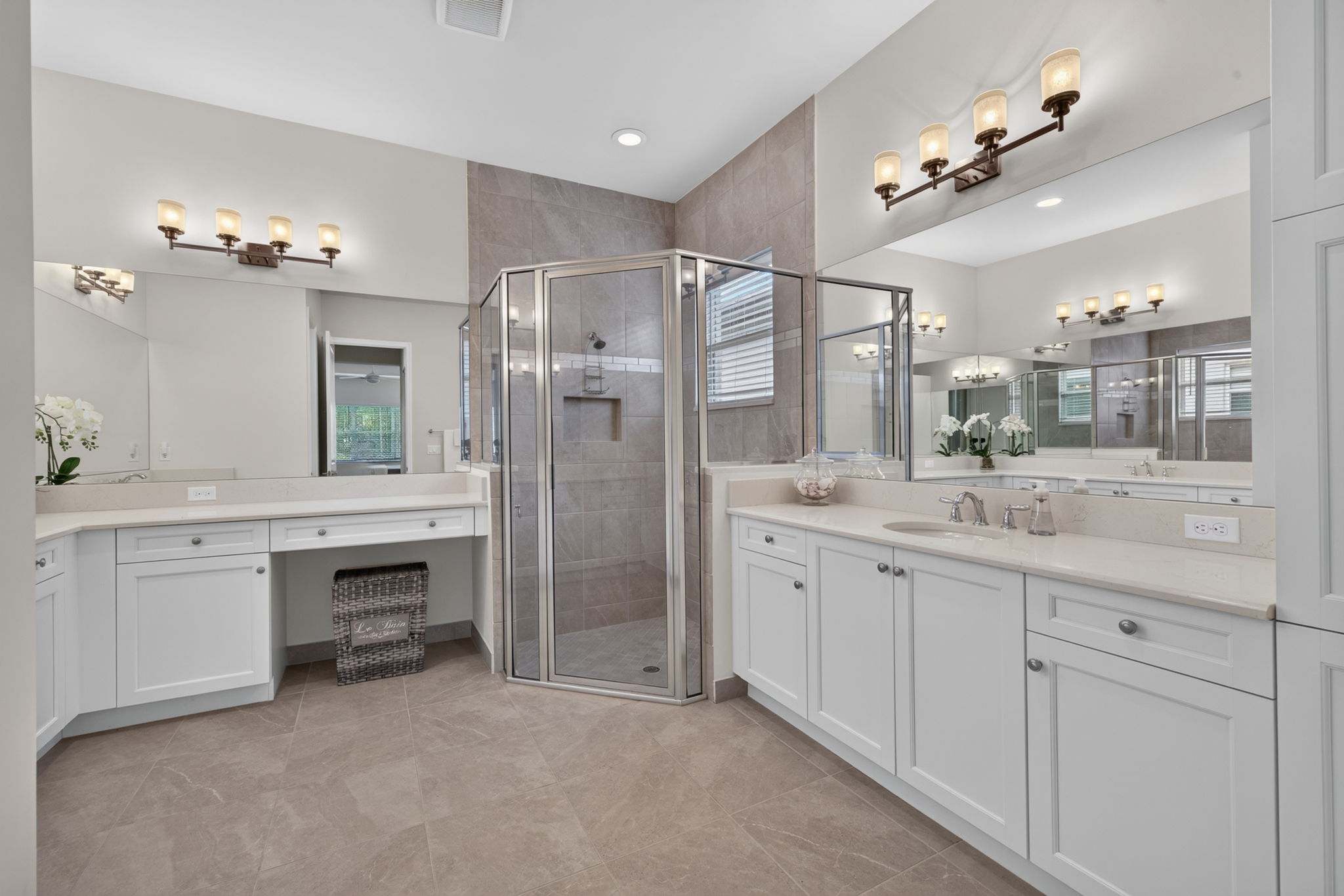 Spacious corner shower, vanity area, double basins, AND a large linen closet!