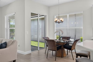 A 2nd set of sliders to the pool area plus 2 windows make this breakfast nook bright and cheery!