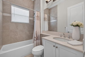 All 3 full baths feature to the ceiling tile upgrade! This one is the shared bath to the right of the foyer and adjacent to the 3rd bedroom. Bathroom 3