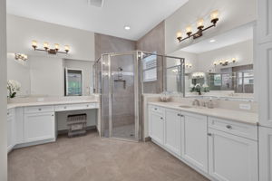Spacious corner shower, vanity area, double basins, AND a large linen closet!