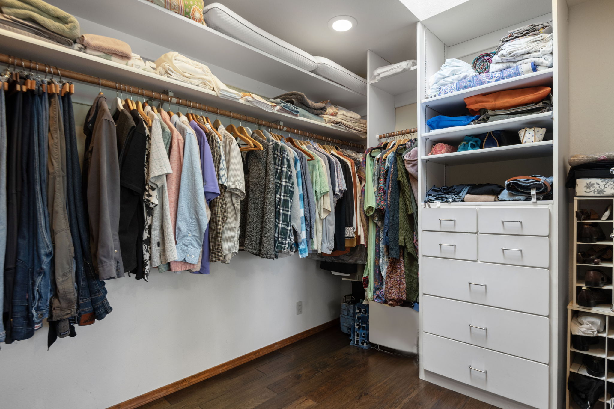 Primary walk-in closet has custom built-in storage