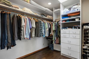 Primary walk-in closet has custom built-in storage