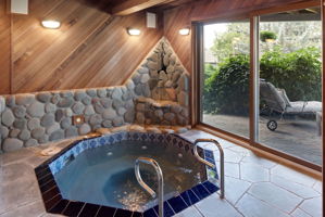 Custom sunken hot tub with outside access and water feature