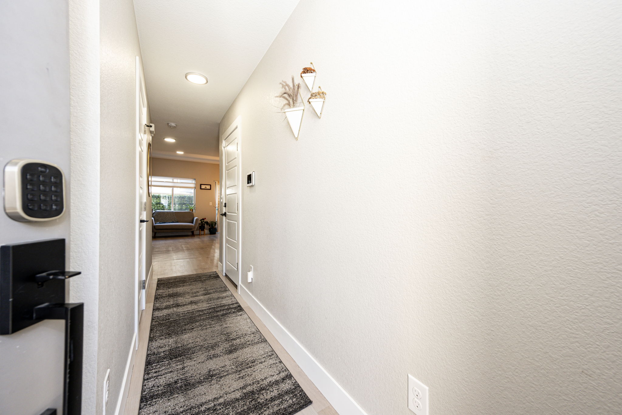 View as you enter the home. The half bathroom is located down the hallway to the left. Garage door entrance is down the hallway to the right.