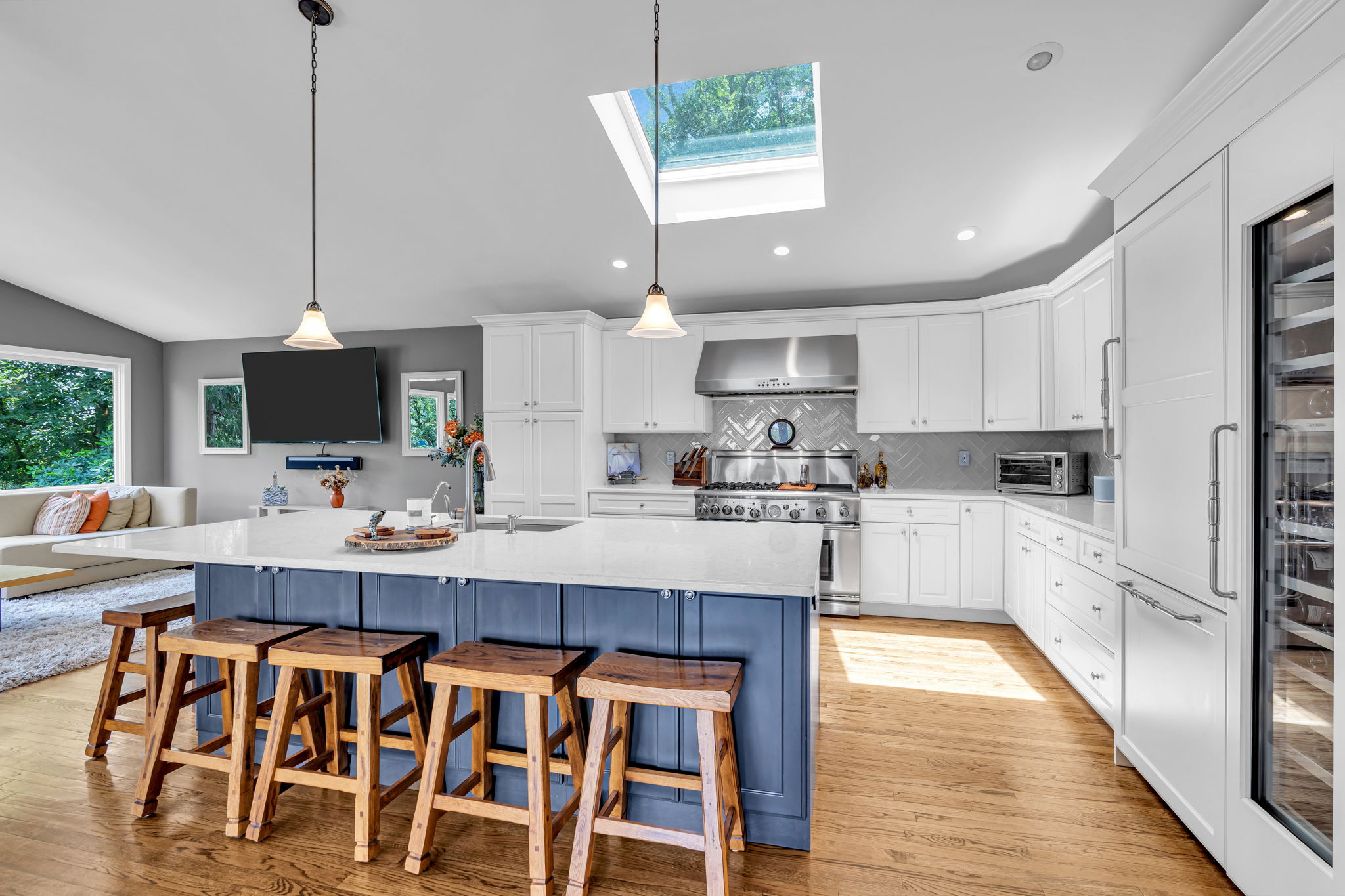 Casual dining at the center island with skylights and pendent lighting