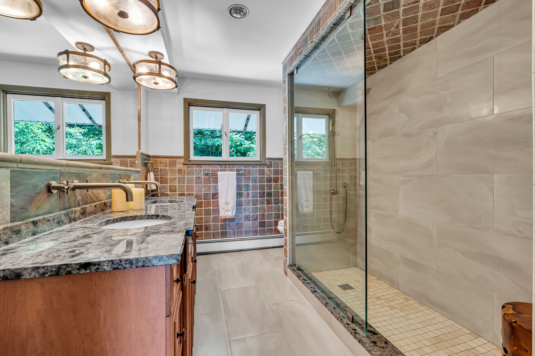 1st floor renovated guest bath, double glass walk-in shower, double vanity, tile surround