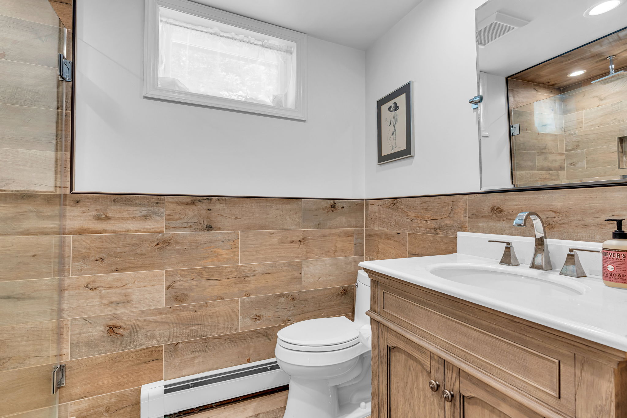 Lower level full bath with glass enclosed tiled surround shower