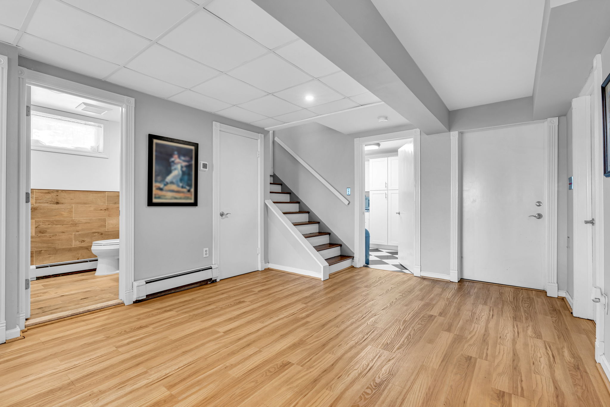 Lower level foyer from built-in garage with view to laundry rm and full bath
