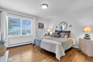 Bedroom #3, wood flooring, custom blinds, double closet, hardwood flooring, views to lake