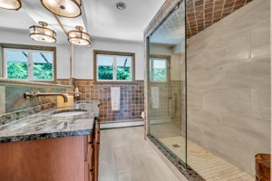 1st floor renovated guest bath, double glass walk-in shower, double vanity, tile surround
