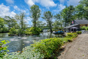 Walking path to lakefront cabana and outdoor kitchen