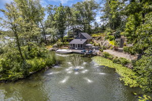 Waterfront fountain off private island with view to lakeside cabana