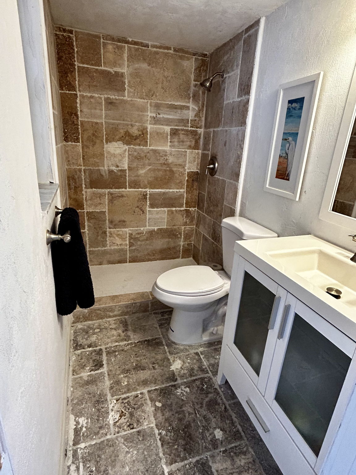 Downstairs full bathroom with Travertine