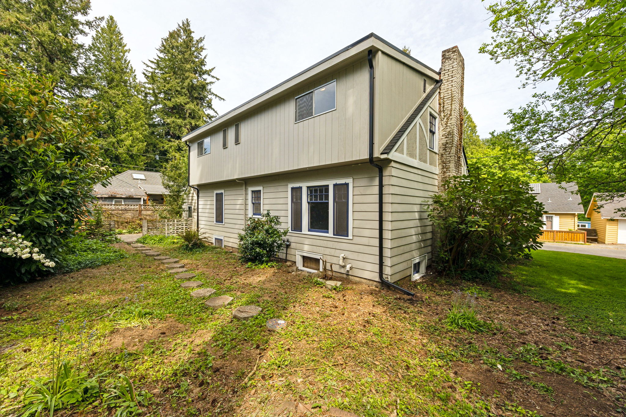 Back view of the two story home, with a cute little partially fenced back yard.