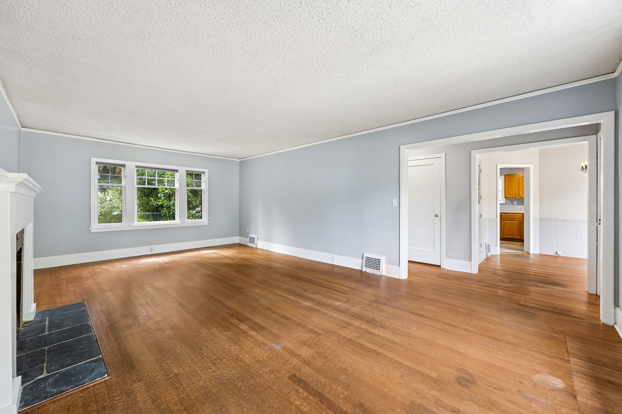 View from living room, looking towards hallway and dining room.