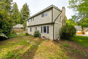 Back view of the two story home, with a cute little partially fenced back yard.