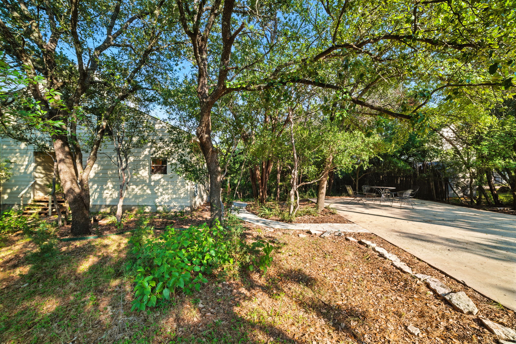 A long, private driveway leads to this treehouse-style home tucked among mature trees on a spacious 0.68-acre lot. The serene setting provides exceptional privacy and a true Austin retreat feel, while still being just steps from Lake Austin and within the highly acclaimed Eanes ISD.