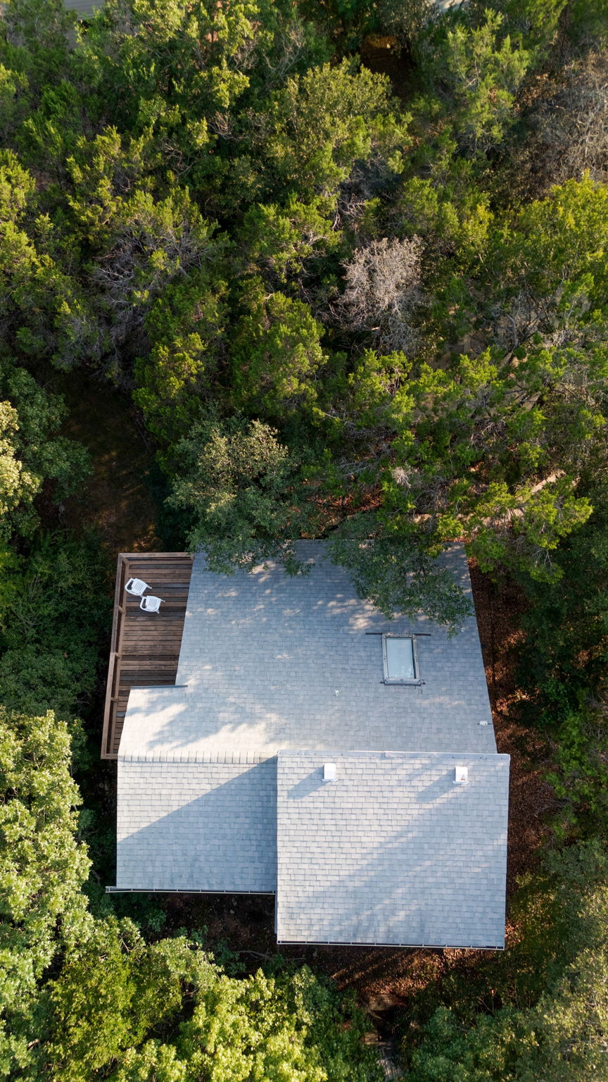 The bird’s-eye view highlights the home’s thoughtful placement, maximizing privacy while allowing for outdoor living on the spacious deck. Whether enjoying the wooded surroundings or spotting deer in the yard, this home offers a rare blend of nature, comfort, and location in coveted Eanes ISD