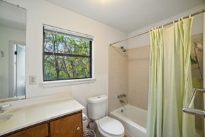 The primary ensuite bathroom offers both privacy and convenience with a full tub-shower combination and a bright window that brings in natural light. Positioned just off the primary bedroom, it provides a functional retreat to start and end the day in comfort.