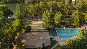An overhead look at the Lake Hills Community Association, where the lake and surrounding amenities create a lifestyle that feels like an extension of home. Whether it’s a day on the water, an afternoon at the pool, or simply relaxing under the trees at one of the picnic areas, these optional features capture the balance of convenience and leisure that make this neighborhood so unique.